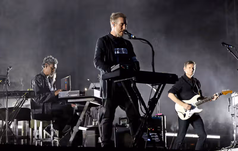 Massive Attack say entire band were detained and some had passports confiscated in Singapore after Palestine flag display